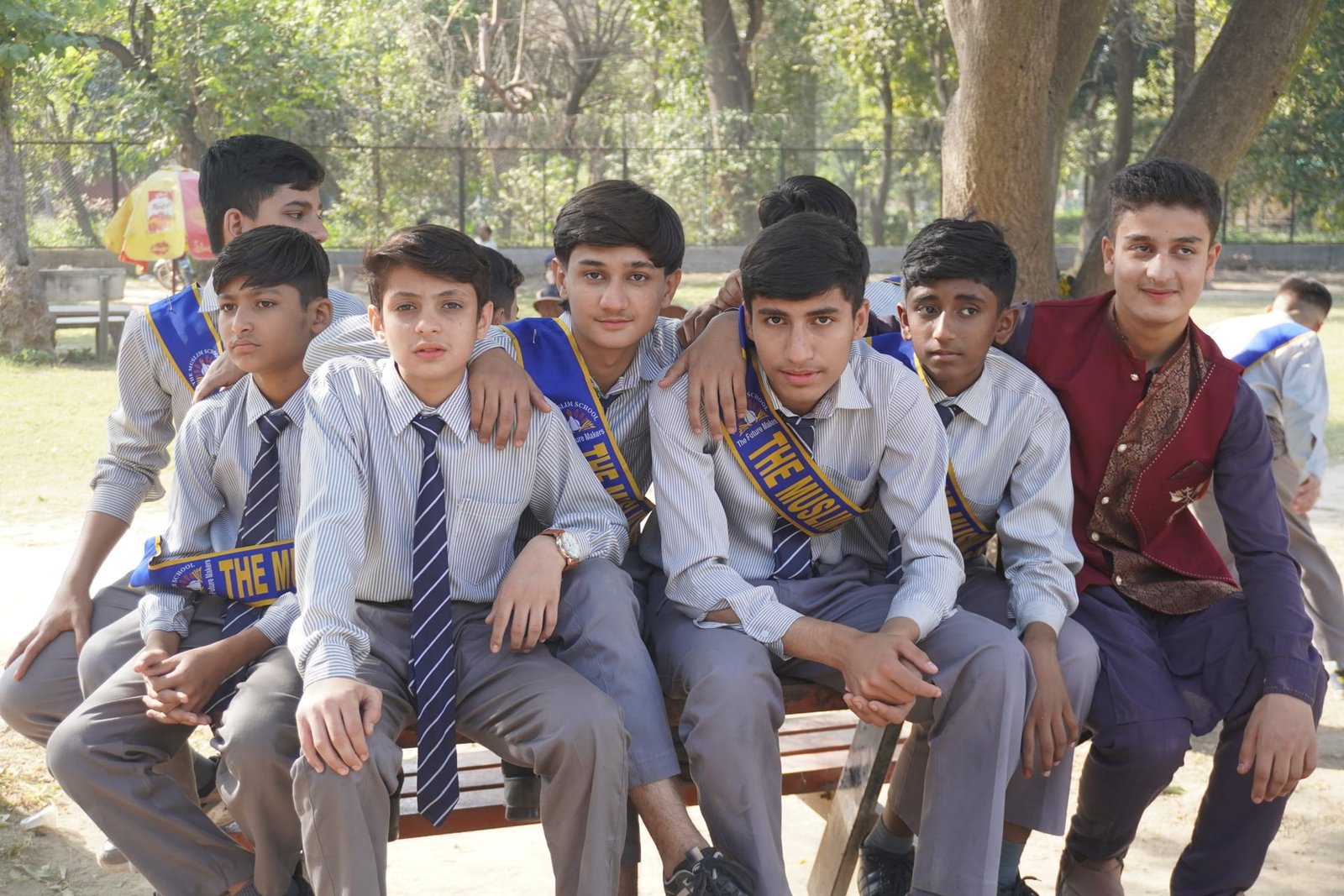 Students sitting together during an outdoor school group visit.